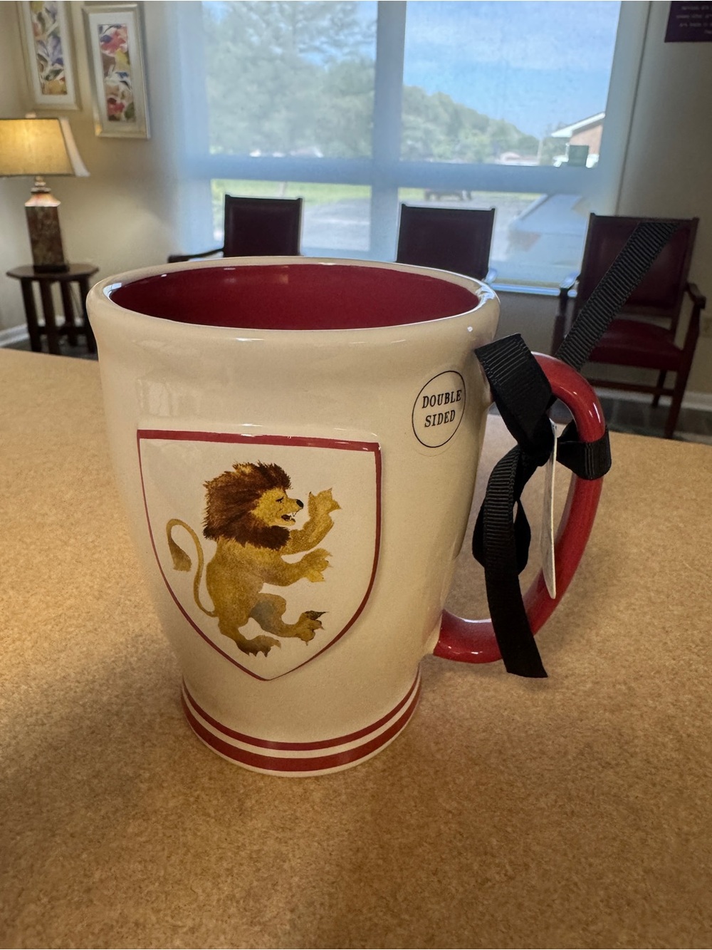 Ceramic mug titled 'Gryffindor House Crest Mug' by Rae Dunn